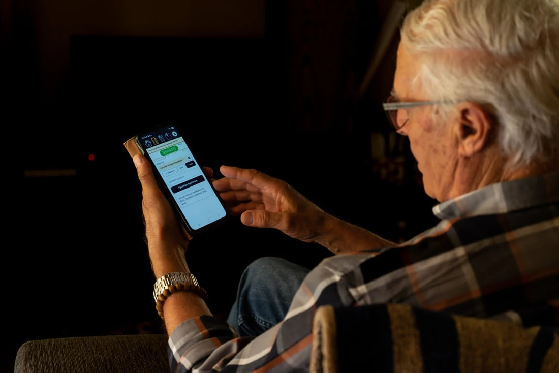 My father using WizTick on his phone at home